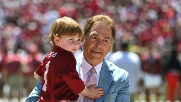 Alabama head coach Nick Saban holds his grandson before the A-Day game at Bryant-Denny Stadium.